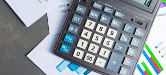 Checking accounting report on business table. Calculator
